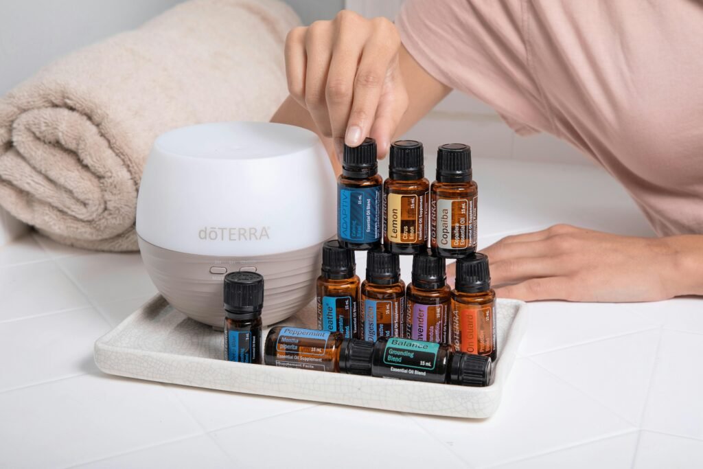 A tray with essential oils, a diffuser, and a towel for a relaxing spa ambiance.